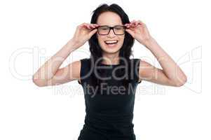 Charming lady adjusting her eyeglasses