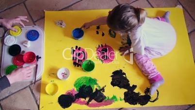 Little Girl Painting With Hands Full