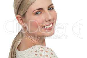 Tight face closeup of smiling teen blonde girl