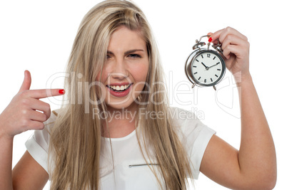 Girl pointing towards old fashioned time piece