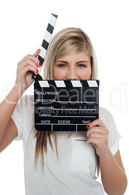 Beautiful female with clapperboard. It's showtime.