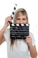 Beautiful female with clapperboard. It's showtime.