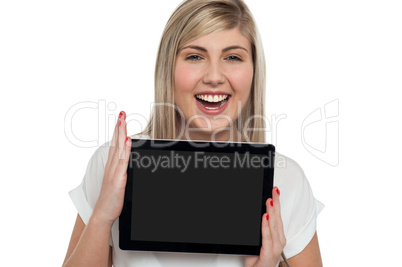 Active caucasian girl displaying tablet device