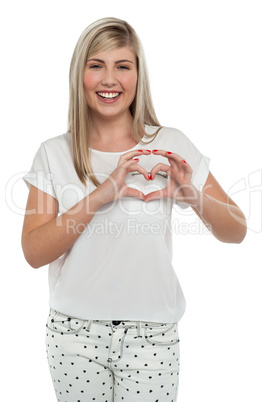 I am in love. Girl making heart with fingers.