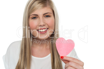 Pretty girl holding cute pink paper heart