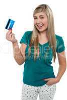 Joyous teenager displaying credit card