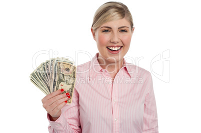 Pretty woman holding fan made of money
