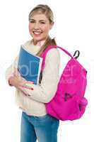 Joyful college student posing with pink backpack