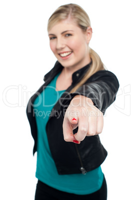 Fashionable teen in leather jacket pointing at you