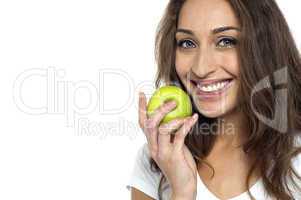 Health conscious woman about to eat fresh green apple