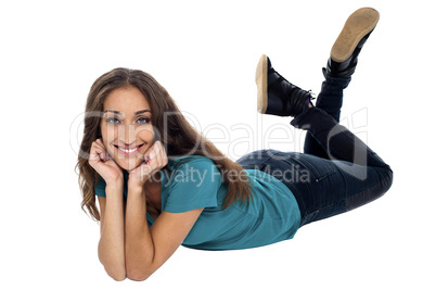 Elegant female with cheeky expression relaxing on the floor
