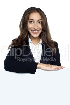 Female executive behind blank white ad board