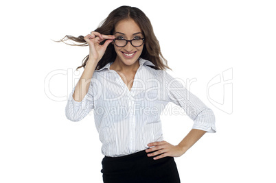 Young businesswoman adjusting her spectacles