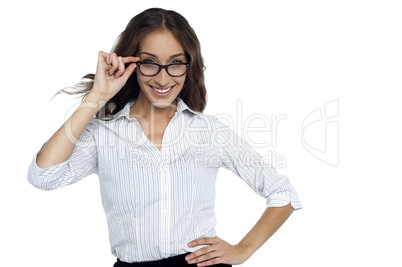 Smiling female executive adjusting her eye wear