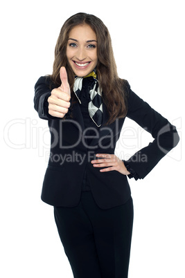 Joyous young stewardess gesturing thumbs up