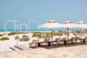Sunbeds and umbrellas at the beach of luxury hotel, Abu Dhabi, U