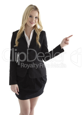 Beautiful young businesswoman pointing at white copyspace