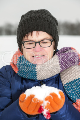 Woman holding snow in their hands