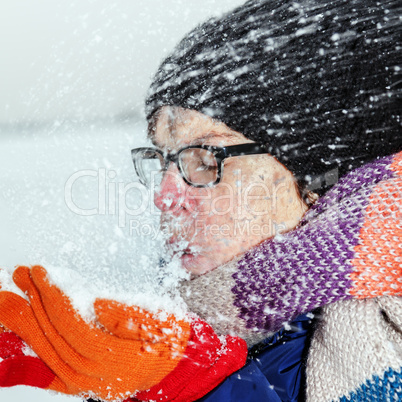 Woman holding snow in their hands