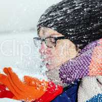 Woman holding snow in their hands