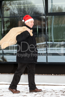 Man with cloth bag runs through the snow