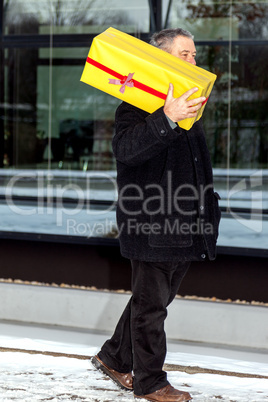 Man running in winter weather with package