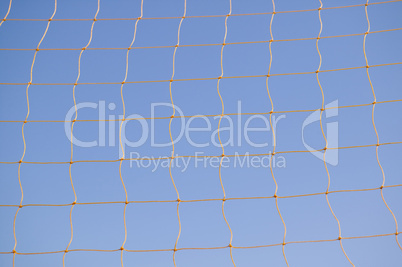 Soccer net against blue sky