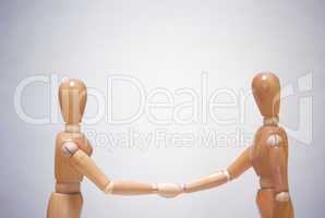 Two mannequins shaking hands