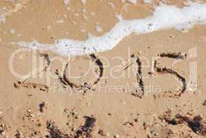 sand number 2015 on beach with wave