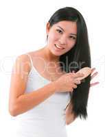 Asian girl combing hair