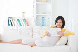 Asian  pregnant woman using tablet computer
