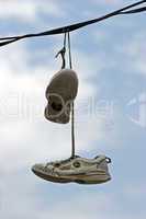 Tennis shoe pair over power line