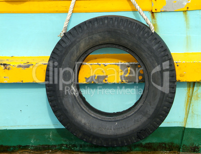 Old tyre on wooden boat
