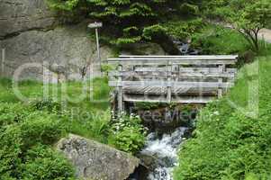 Wooden bridhe across a water stream