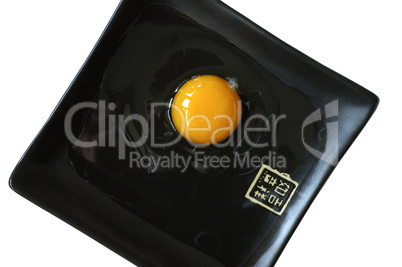 Egg yolk on a black Japanese plate