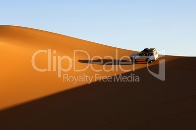 Jeep riding on a sand dune in the S