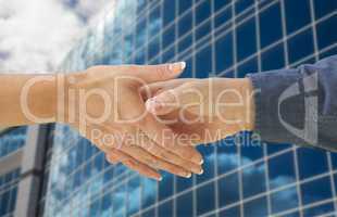 Man and Woman Shaking Hands In Front of Building
