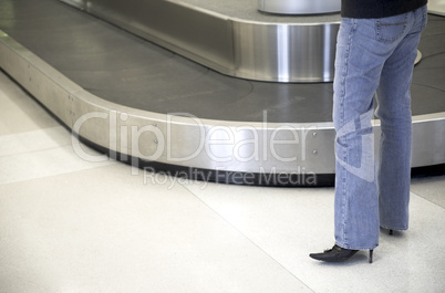 Woman waits for luggage