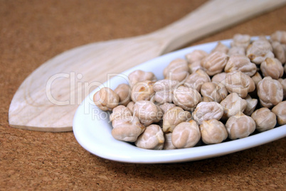Raw chickpeas in a small plate  on a table