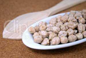 Raw chickpeas in a small plate  on a table