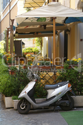 Scooter and outdoor restaurant