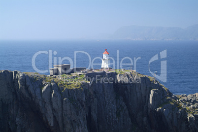 Small lighthouse on cliff in Norway