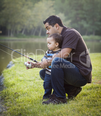 Happy Young Ethnic Father and Son Fishing