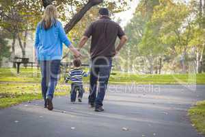 Happy Mixed Race Ethnic Family Walking In The Park