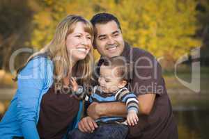 Happy Mixed Race Ethnic Family Playing In The Park