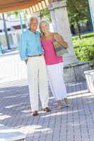 Happy Senior Couple Smiling Outside in Sunshine