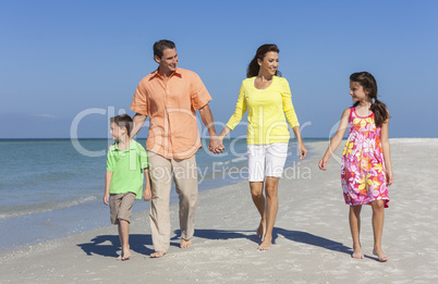 Mother, Father and Children Family Walking On Beach