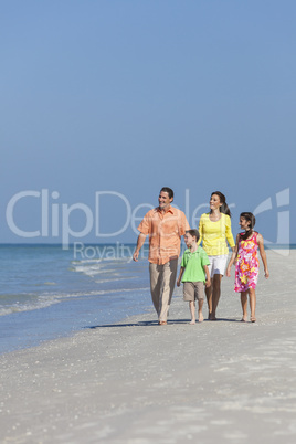 Mother, Father and Children Family Walking On Beach