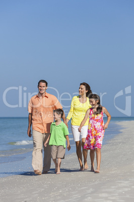 Mother, Father and Children Family Walking On Beach