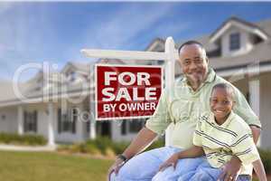Father and Son In Front of For Sale By Owner Sign and House